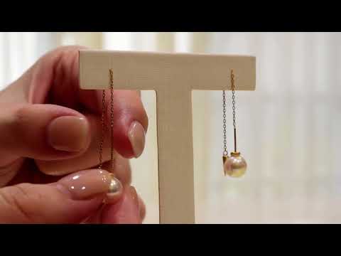 Qlassico dangling earrings from the  Celestial Capsule, featuring a pair of round Akoya pearls set in 18K yellow gold.