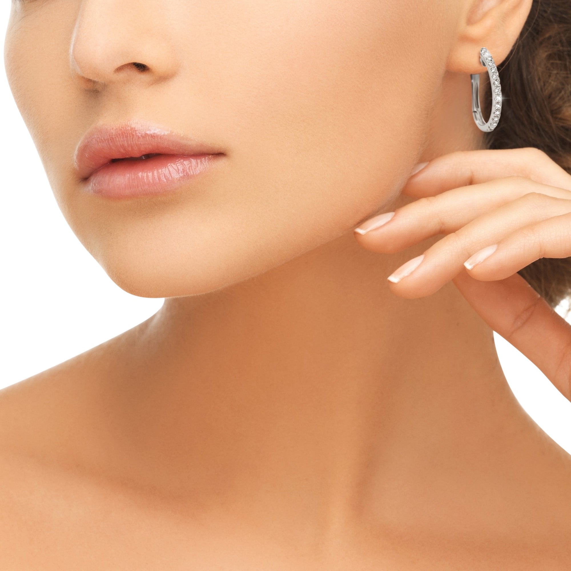 Model wearing a pair of Qlassico diamond hoop earrings, featuring natural diamonds set in 14K white gold.